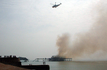 Smoldering West Pier and helicopter
